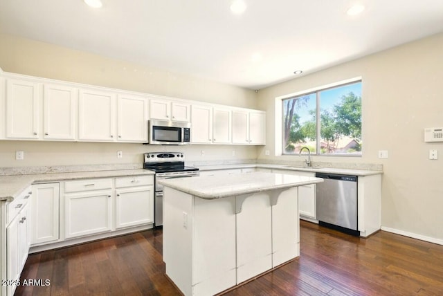 2880 E Nunneley Rd, Gilbert, AZ 85296 - kitchen featuring appliances with stainless steel finishes, white cabinetry, dark wood-style floors, recessed lighting, and a center island