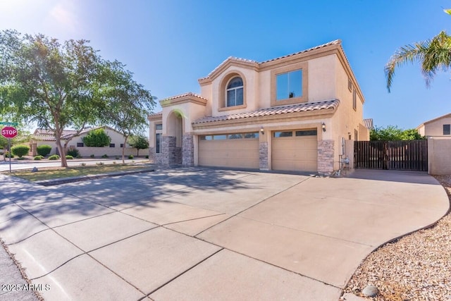 2880 E Nunneley Rd, Gilbert, AZ 85296 - mediterranean / spanish home featuring an attached garage, stone siding, stucco siding, driveway, and a tile roof
