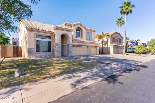 2880 E Nunneley Rd, Gilbert, AZ 85296 - mediterranean / spanish-style home with stucco siding, an attached garage, a tiled roof, concrete driveway, and stone siding