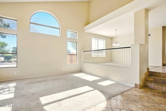 2880 E Nunneley Rd, Gilbert, AZ 85296 - carpeted empty room featuring a chandelier, baseboards, and a high ceiling