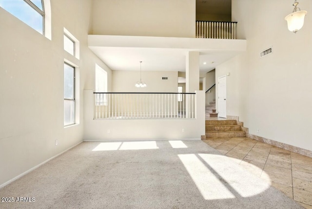 2880 E Nunneley Rd, Gilbert, AZ 85296 - spare room with a towering ceiling, a chandelier, healthy amount of natural light, stairway, and baseboards