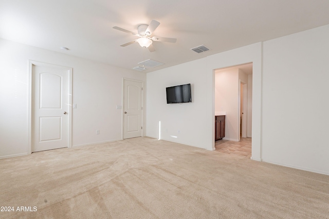 unfurnished room with ceiling fan and light carpet