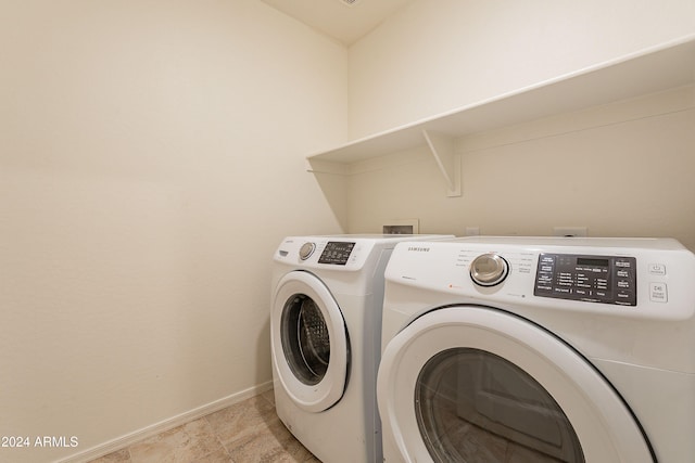 laundry area featuring washing machine and clothes dryer