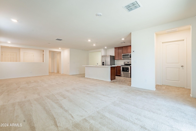 unfurnished living room with light colored carpet