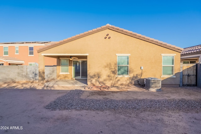 back of house with central AC unit, ceiling fan, and a patio area