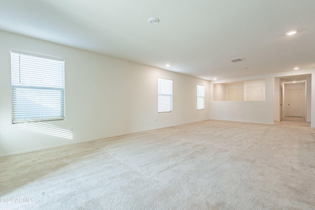 spare room featuring light colored carpet