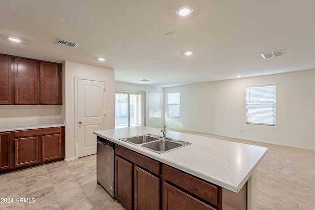 kitchen featuring dishwasher, sink, and a center island with sink