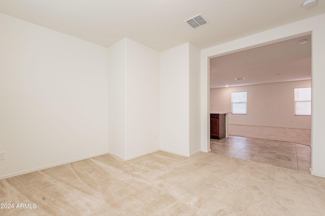 empty room featuring light carpet