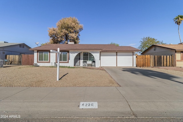 ranch-style house featuring a garage