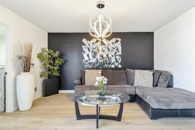 living room with light hardwood / wood-style flooring and a notable chandelier