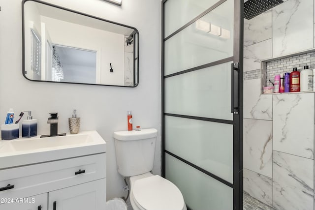 bathroom with vanity, an enclosed shower, and toilet