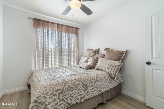 bedroom featuring ceiling fan and light hardwood / wood-style flooring