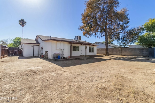 rear view of house featuring central AC unit