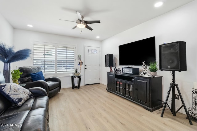 living room with light wood-type flooring and ceiling fan