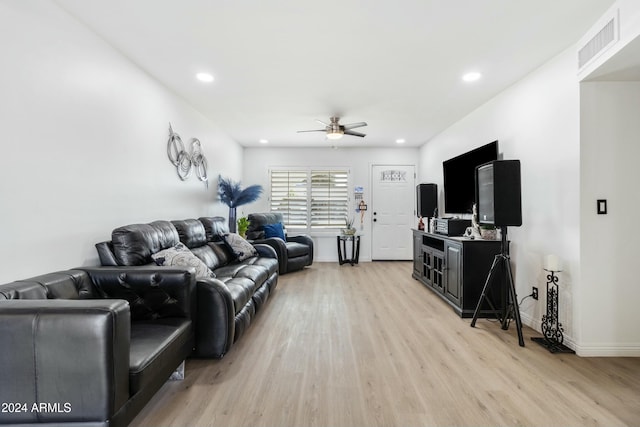 living room with ceiling fan and light wood-type flooring