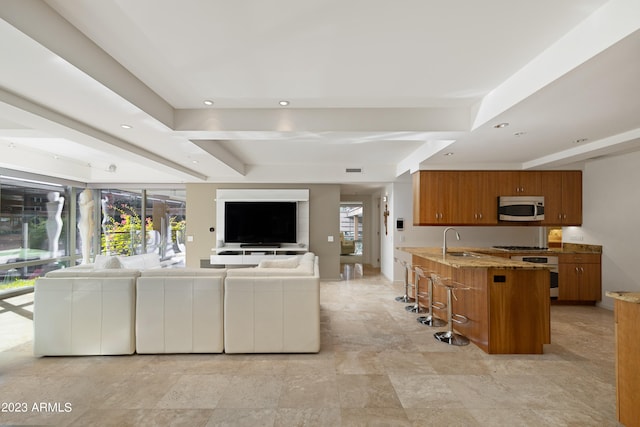 tiled living room featuring a raised ceiling and sink