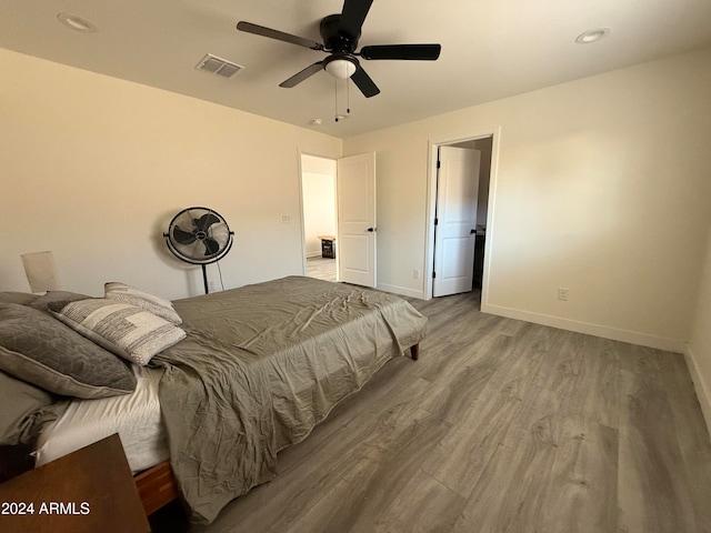 bedroom with ceiling fan and light wood-type flooring