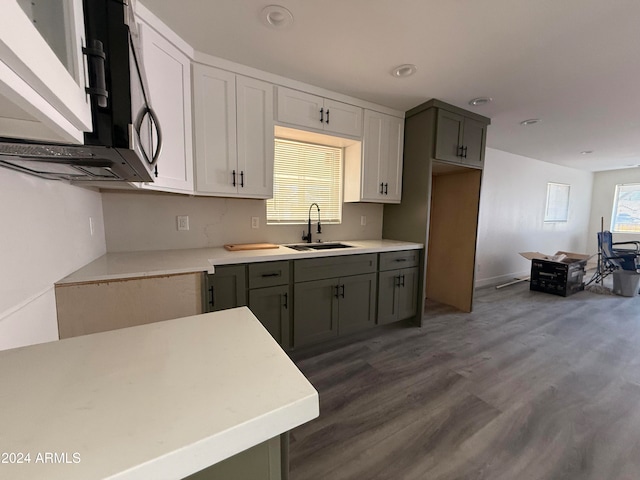 kitchen featuring gray cabinetry, dark wood-type flooring, and sink