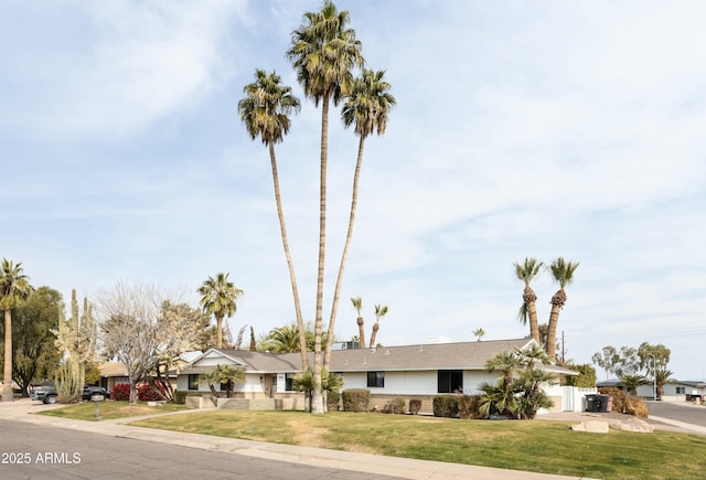 single story home with a garage and a front lawn