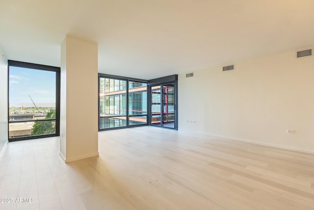 4808 N 24th St Unit 923, Phoenix, AZ 85016 - unfurnished room with floor to ceiling windows and light wood finished floors