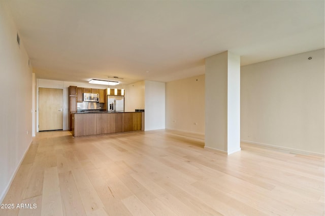 4808 N 24th St Unit 923, Phoenix, AZ 85016 - unfurnished living room with light wood-style floors and baseboards