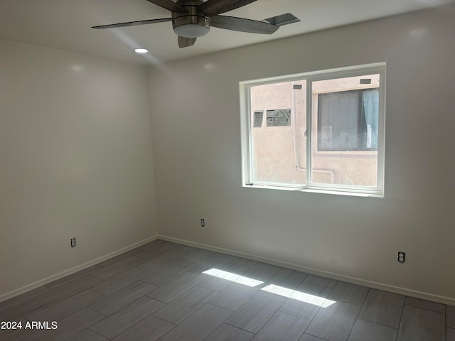 spare room featuring hardwood / wood-style floors and ceiling fan