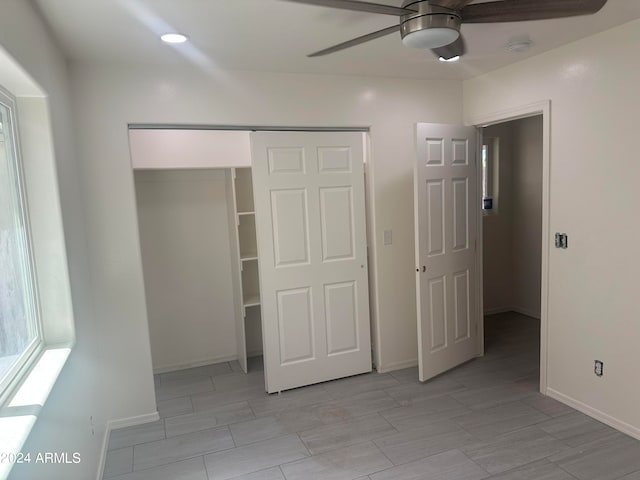 unfurnished bedroom featuring ceiling fan and a closet