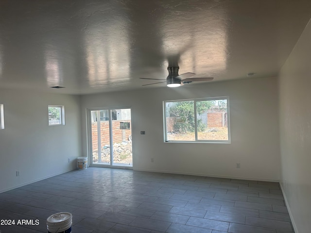 unfurnished room with ceiling fan