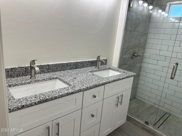 bathroom featuring hardwood / wood-style floors, vanity, and an enclosed shower