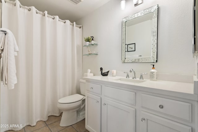 bathroom featuring vanity, tile patterned floors, and toilet