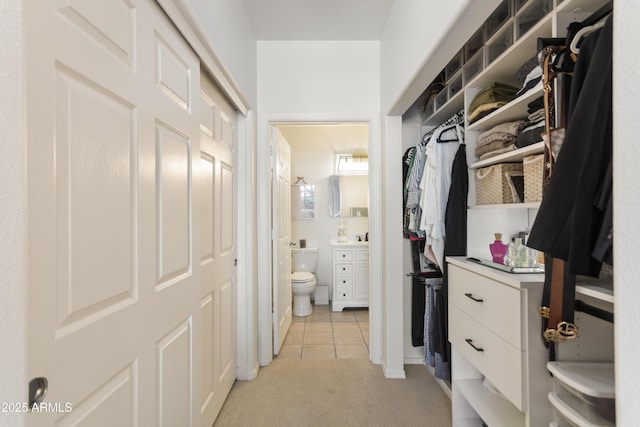 spacious closet with light tile patterned floors