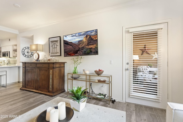 interior space featuring crown molding and light wood-type flooring