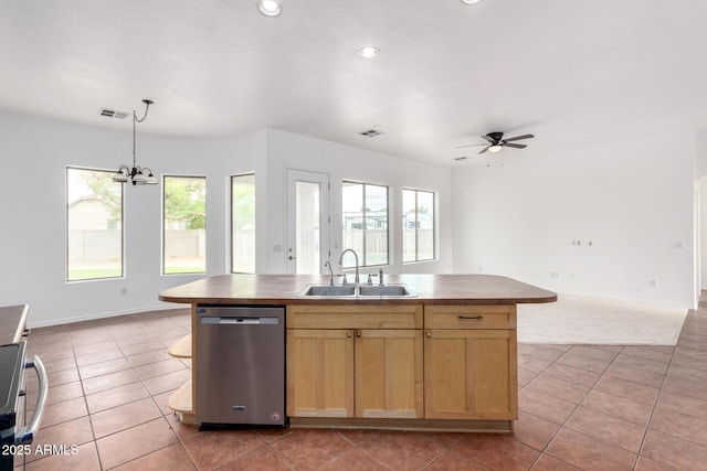 kitchen featuring visible vents, dishwasher, a sink, open floor plan, and ceiling fan with notable chandelier