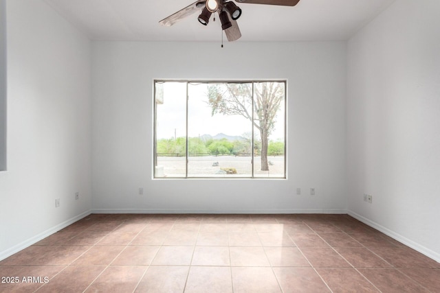 unfurnished room featuring light tile patterned floors, baseboards, and ceiling fan