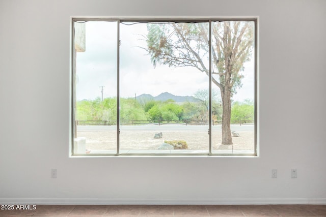 interior space with a mountain view and baseboards