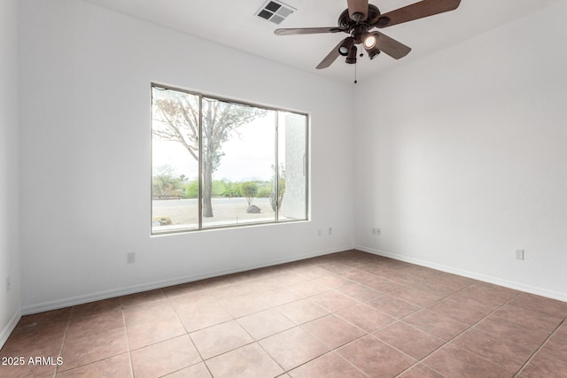 empty room featuring visible vents, baseboards, a ceiling fan, and light tile patterned floors