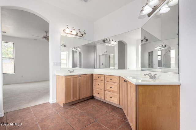full bathroom with tile patterned flooring, double vanity, a sink, and ceiling fan