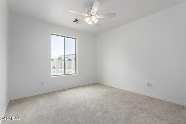 empty room with ceiling fan, baseboards, visible vents, and carpet floors