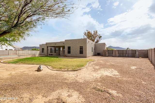 back of property with a swimming pool, a yard, a fenced backyard, stucco siding, and a patio area