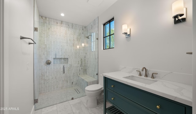 bathroom featuring vanity, an enclosed shower, and toilet