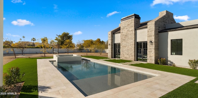 view of swimming pool with a yard and a patio area