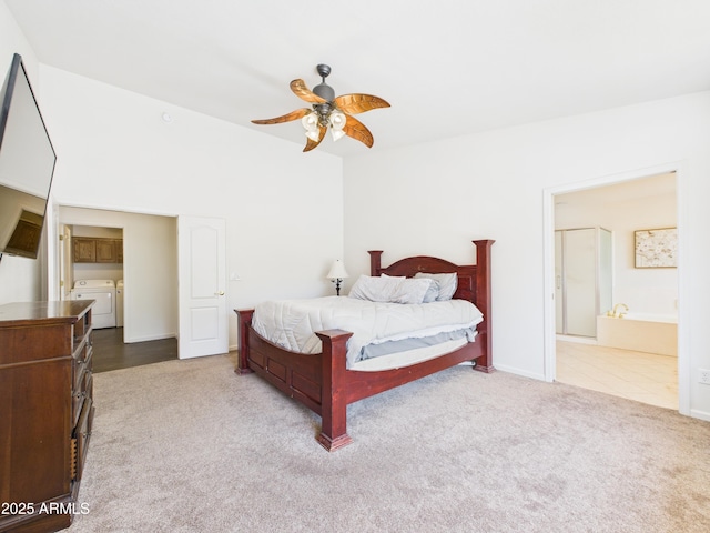 carpeted bedroom featuring independent washer and dryer, baseboards, a ceiling fan, and ensuite bath