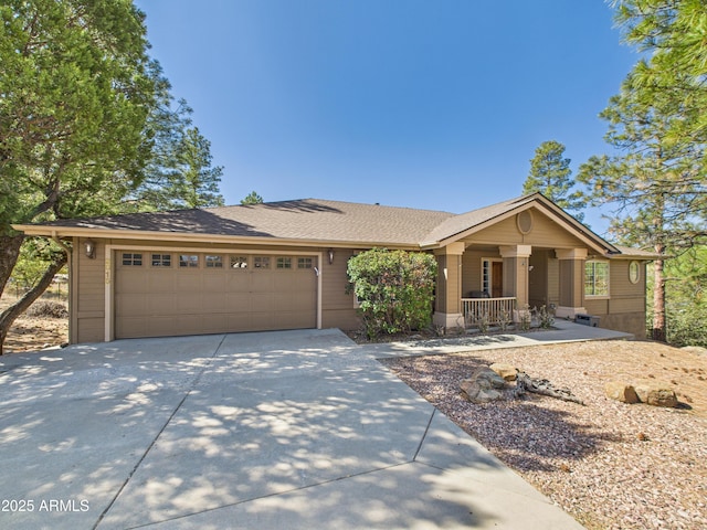 ranch-style house featuring driveway, a garage, covered porch, and a shingled roof