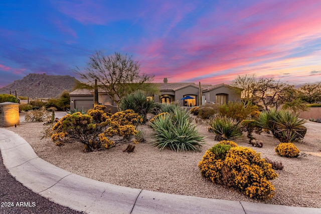 view of front of home with a mountain view and a garage