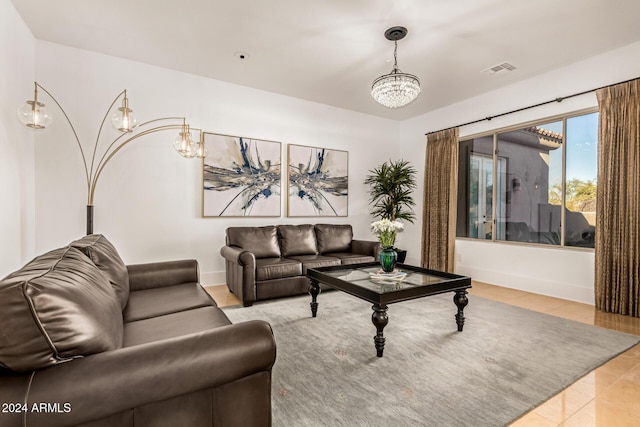 tiled living room with an inviting chandelier