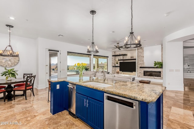 kitchen with dishwasher, a kitchen island with sink, blue cabinetry, and sink