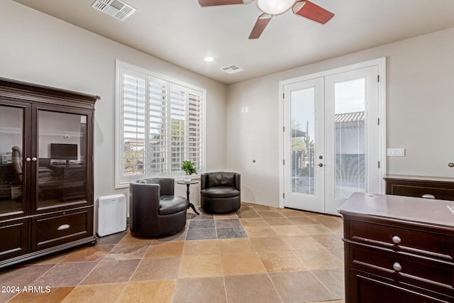 sitting room with ceiling fan and french doors