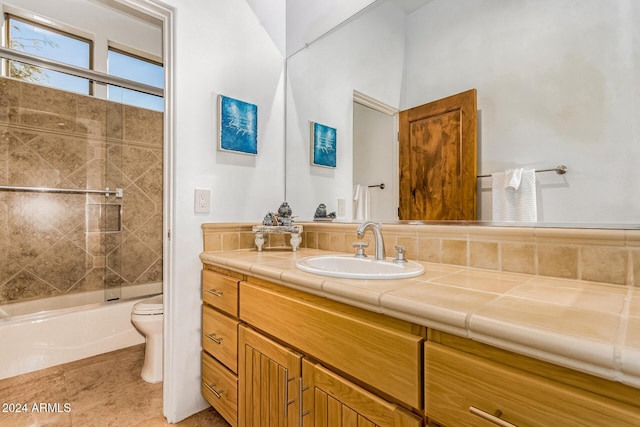 full bathroom with vanity, toilet, and tiled shower / bath