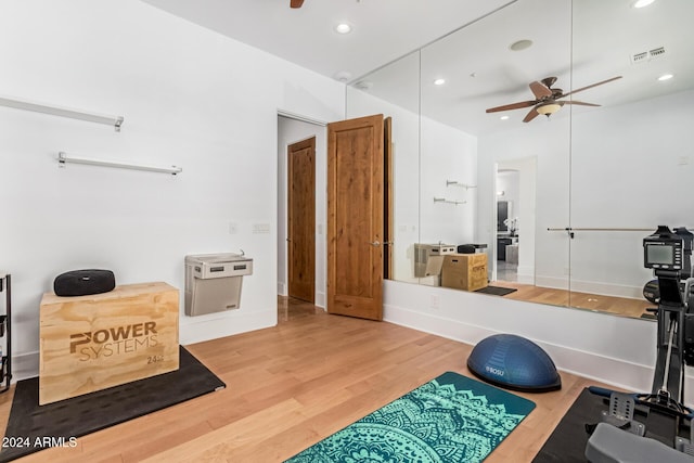 workout room featuring hardwood / wood-style floors and ceiling fan