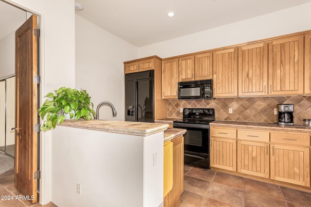 kitchen with sink, backsplash, and black appliances